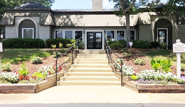 Exterior view of the apartment, with leafy trees on the sides